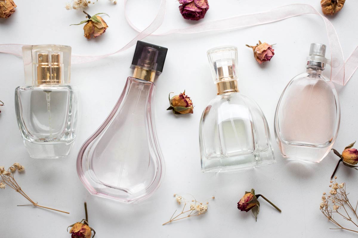 Bottles of perfume with background of roses